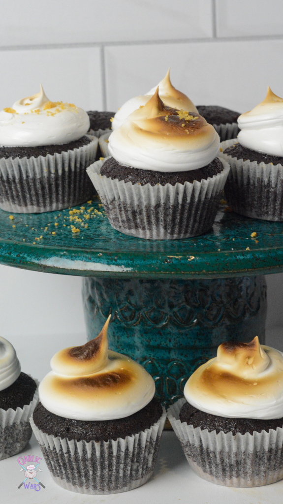 smores cupcakes on teal cake stand with cupcakes on surrounding table