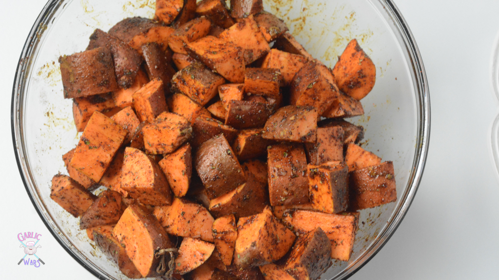 Sweet potato home fries tossed in spices before baking.