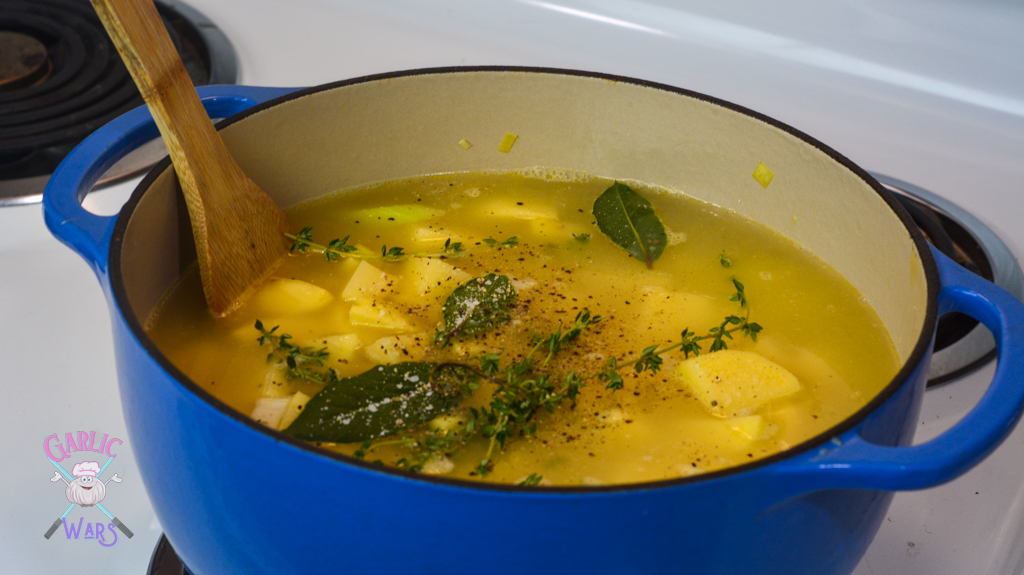 herbs, spices, chicken broth, and potatoes added to the pot