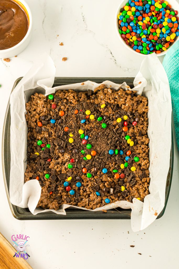 m&ms and chocolate chips pressed into rice krispie treats